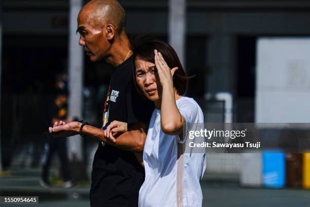 Woman blocks the sun with her hand during a heat wave on July 24, 2023 in Hong Kong, China. A prolonged heat wave in Hong Kong caused the Observatory...