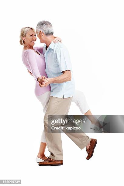 happy mature couple dancing - senioren koppel studio stockfoto's en -beelden