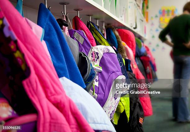 elementary school coat rack: backpacks - coat stand stock pictures, royalty-free photos & images