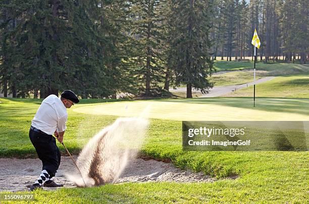 classy male caucasian golfer hitting bunker shot - golf argyle stock pictures, royalty-free photos & images