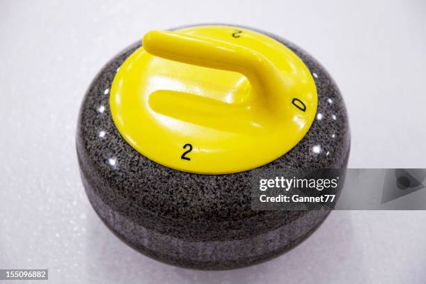 curling stone on ice - curling stone stock pictures, royalty-free photos & images