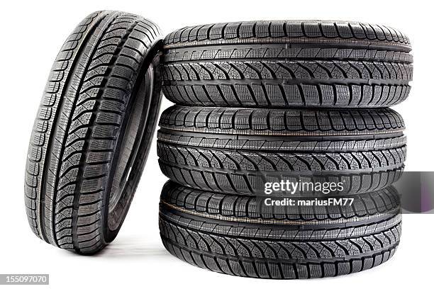 four black brand-new winter tires - tire stack stock pictures, royalty-free photos & images