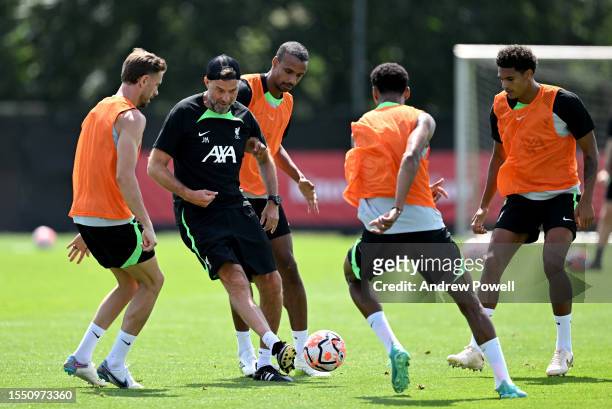 Jurgen Klopp manager of Liverpool playing football with Joel Matip of Liverpool during a training session on July 17, 2023 in UNSPECIFIED, Germany.