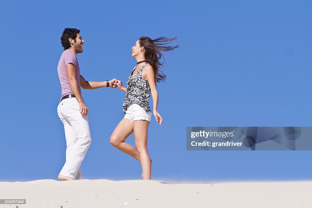 Young  Couple Dancing on Sand
