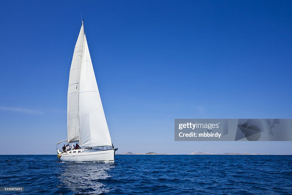 Sailing crew on sailboat