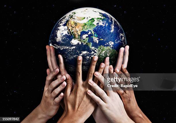 hands cradling mother earth against starfield background - responsibility stock pictures, royalty-free photos & images