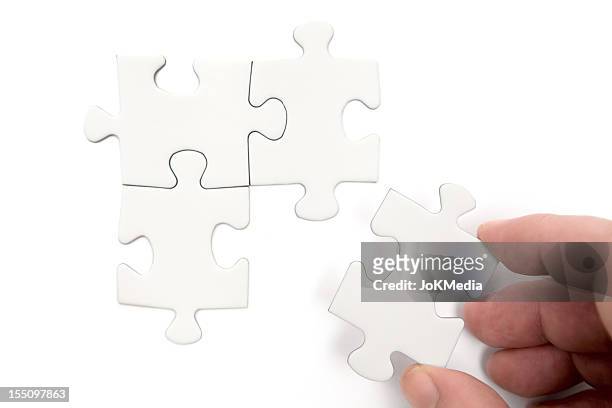 solving the problem - 4 piece puzzle stockfoto's en -beelden