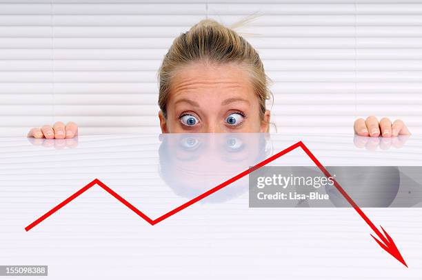 stressed businesswoman analysing moving down graph - great recession stock pictures, royalty-free photos & images