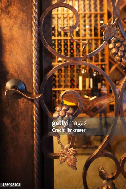 intricate wine cellar door. - wine cellar stock pictures, royalty-free photos & images