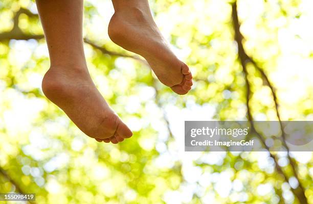 childs hanging bare feet from tree house - barefoot stock pictures, royalty-free photos & images