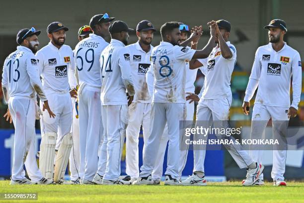 Sri Lanka's Asitha Fernando celebrates with teammates after taking the wicket of Pakistan's Imam-ul-Haq during the first day of the second and final...