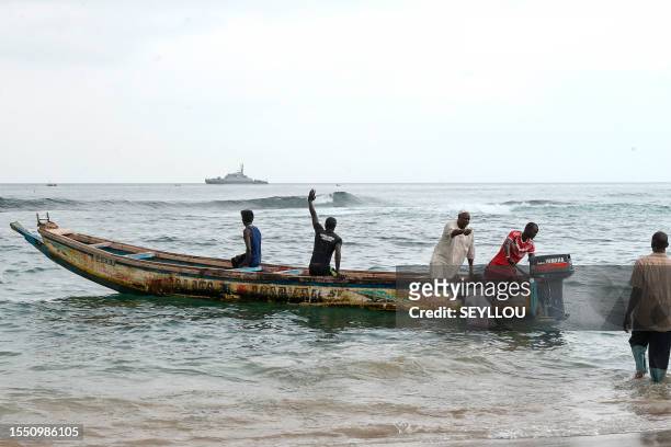 Graphic content / Local fishermen prepare a pirogue for a rescue operation in Ouakam, in Dakar on July 24, 2023 after a boat capsized off the coast...