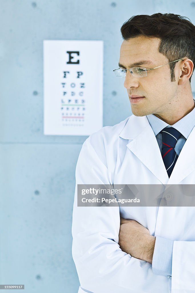 Optician in front of an eye chart