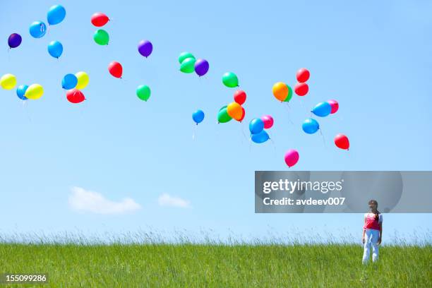 girl with helium balloons - balloons in sky stock pictures, royalty-free photos & images