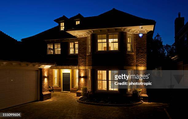beautiful new house at night - security equipment stock pictures, royalty-free photos & images