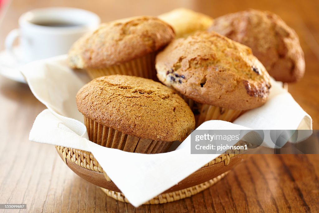Freshly baked muffins on a wooden bowl