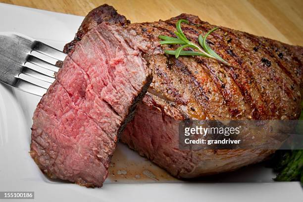 big rib eye beef steak with bite cut out - ribeye biefstuk stockfoto's en -beelden