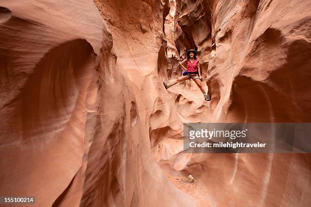woman climbing and hiking slot canyons escalante utah horizontal - slot canyon stockfoto's en -beelden