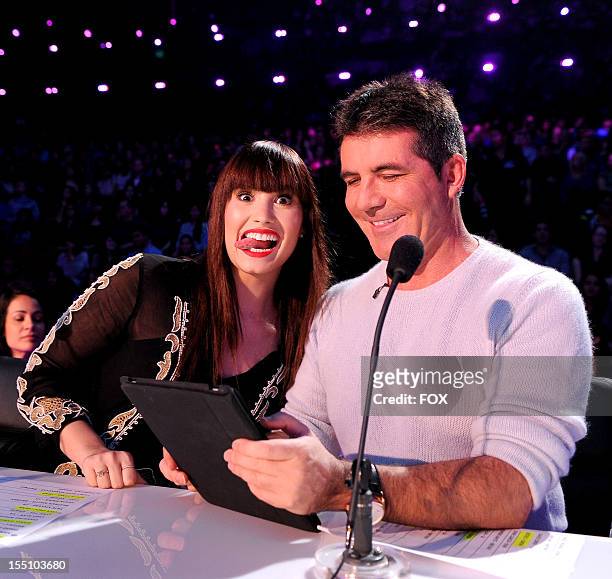 Judges Demi Lovato and Simon Cowell on FOX's "The X Factor" Season 2 Live Performance Show on October 31, 2012 in Hollywood, California.