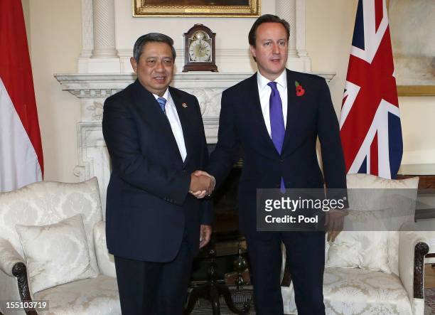 President of the Republic of Indonesia, Susilo Bambang Yudhoyono shakes hands with British Prime Minister David Cameron during a meeting on the...