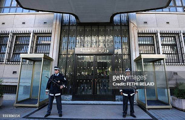 Tunisian policemen stand guard in front of the interior ministry offices in Tunis, on November 1, 2012. Members of different security services...