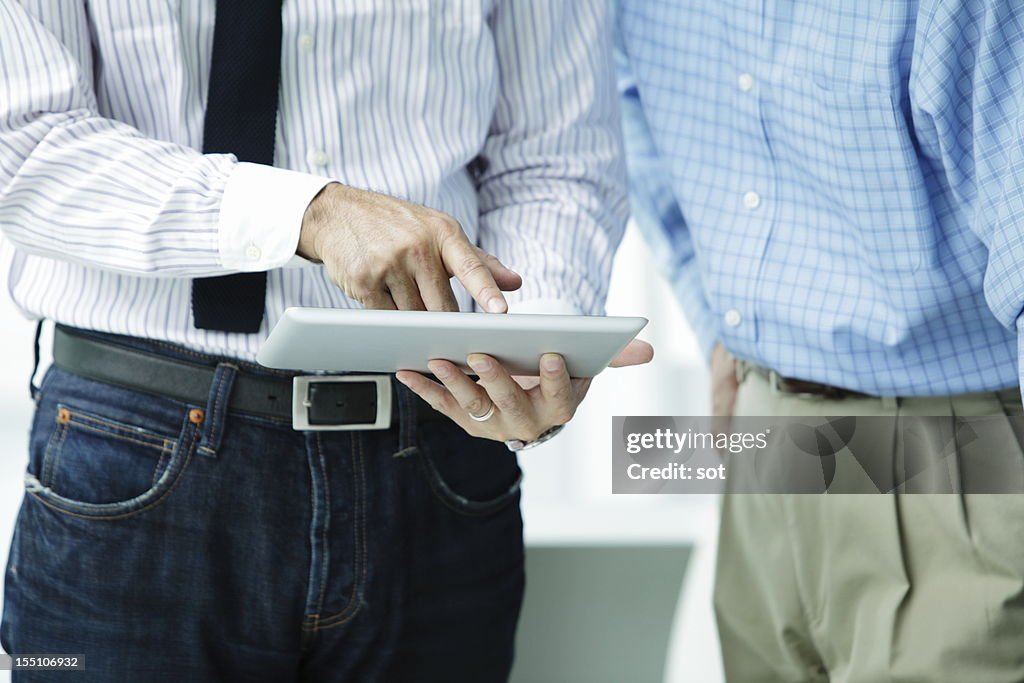 Businessman touching on digital tablet,close up