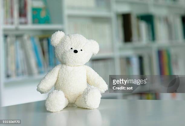 teddy bear in library - teddy bear stock pictures, royalty-free photos & images