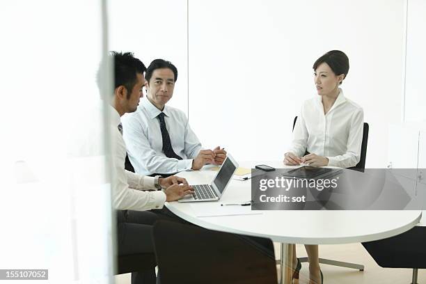 coworkers discussing project in conference room - conference 2012 day 3 stockfoto's en -beelden