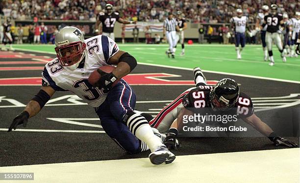 New England Patriots running back, Kevin Faulk, scores a touchdown on a pass reception from quarterback Tom Brady during the first half of Sunday's...