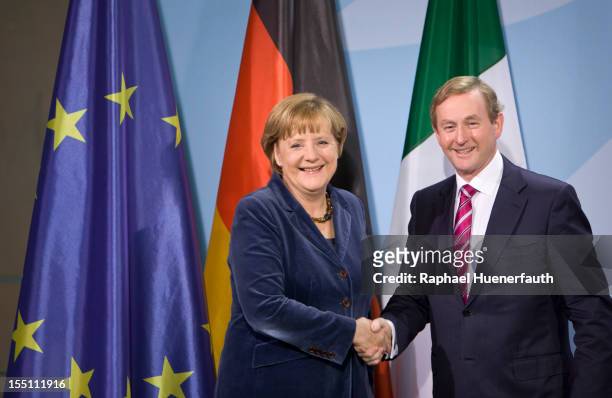 German Chancellor Angela Merkel shakes hands with Irish Taoiseach Enda Kenny after a joint press conference at the Federal Chancellery on November 1,...
