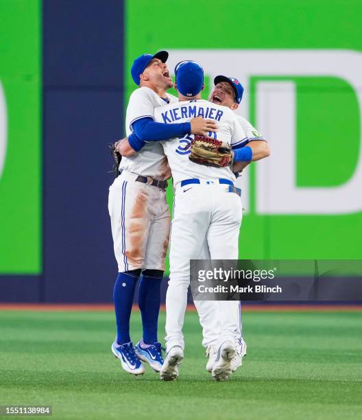 George Springer, Kevin Kiermaier and Daulton Varsho of Toronto Blue Jays celebrate defeating the Arizona Diamondbacks in their MLB game at the Rogers...