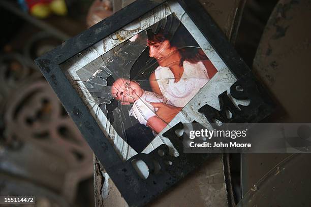 Family photos lie in the debris of Michael Russo's flood damaged home on November 1, 2012 i in the Ocean Breeze area of the Staten Island borough of...