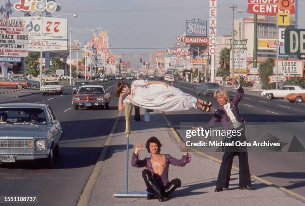 Magicians Siegfried & Roy perform an illusion with an assistant in the middle of Las Vegas Boulevard in October 1977 in Las Vegas, Nevada.