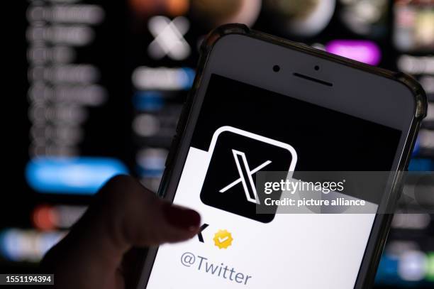 Twitter's official profile on a smartphone screen features the white letter X on a black background. Twitter owner Musk is trying to establish X as...