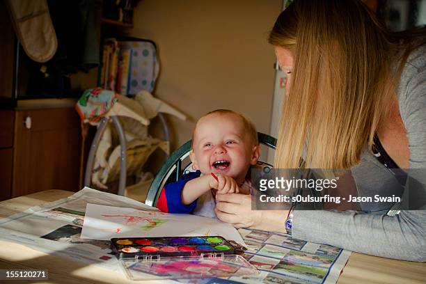 boy with mother - s0ulsurfing stock pictures, royalty-free photos & images