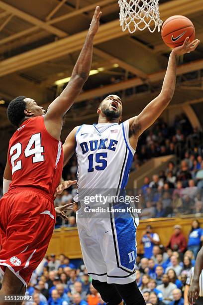 Josh Hairston of the Duke Blue Devils goes to the hoop against Kimani Hunt of the Winston-Salem State Rams at Cameron Indoor Stadium on November 1,...