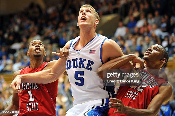 Mason Plumlee of the Duke Blue Devils holds his position against Torez Young-Canty and WyKevin Bazemore of the Winston-Salem State Rams at Cameron...