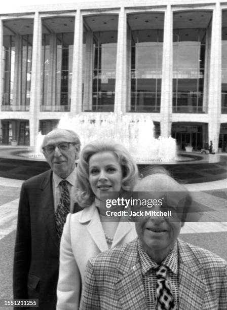 Portrait of, from left, composer Aaron Copland, actress Mary Costa, and conductor Andre Kostelanetz as they pose outside of Lincoln Center, New York,...