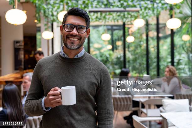 portrait of a happy businessman at a cafe - colombia business breakfast meeting stock pictures, royalty-free photos & images