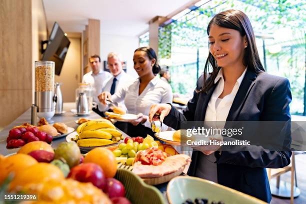 business people eating a buffet breakfast at a convention center - buffet stock pictures, royalty-free photos & images