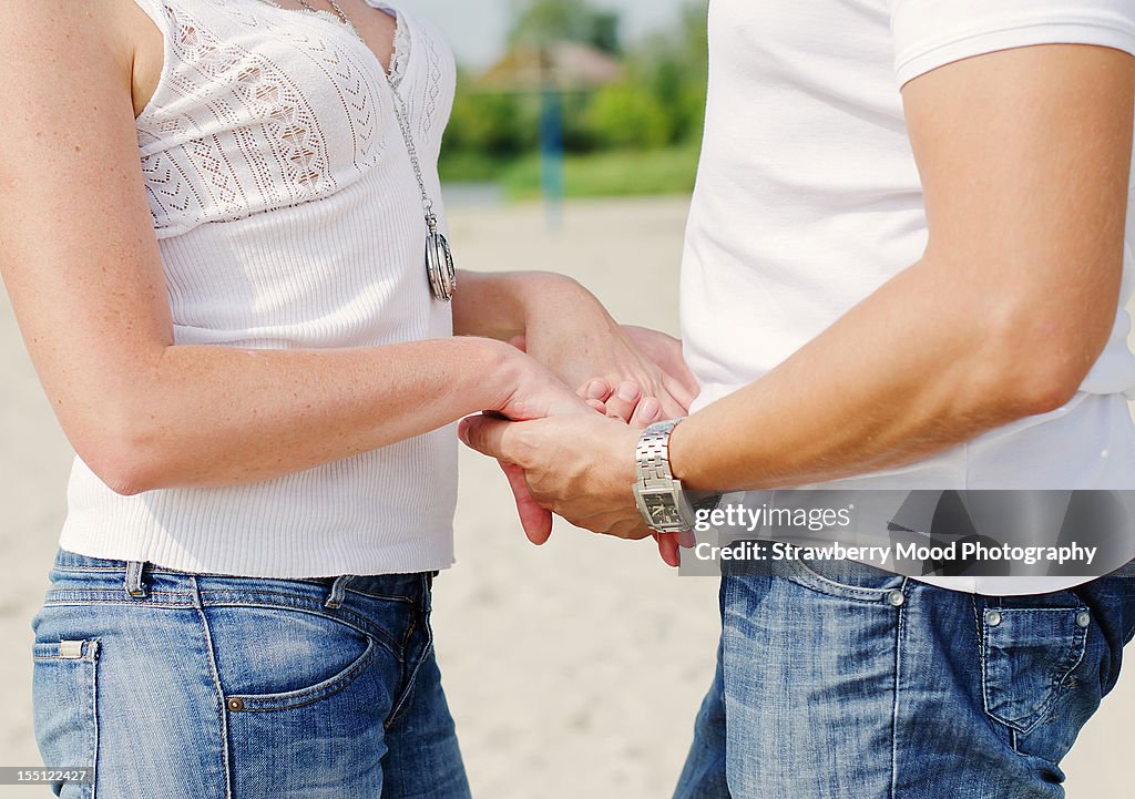 Happy adult couple holding hands