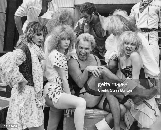 English comedian Freddie Starr poses in London with British dance troupe Hot Gossip, 27th March 1981. Starr is embarking on a British theatre tour...