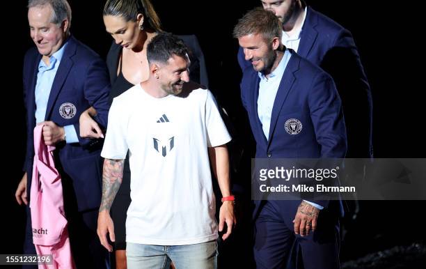 Lionel Messi and David Beckham talk during Inter Miami CF Hosts "The Unveil" at DRV PNK Stadium on July 16, 2023 in Fort Lauderdale, Florida.