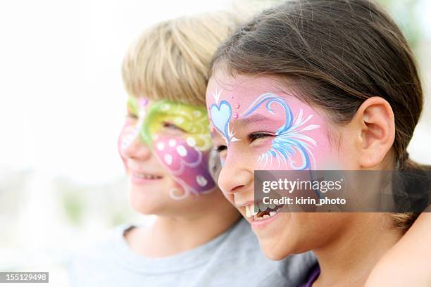 kids with painted faces smiling - face painting stock pictures, royalty-free photos & images