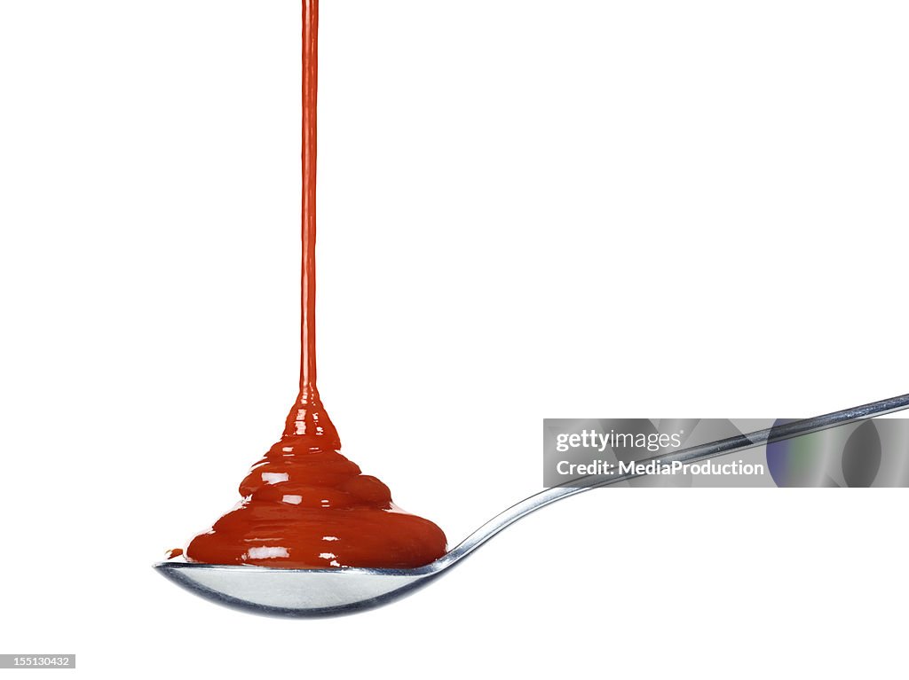 Ketchup pouring on a spoon