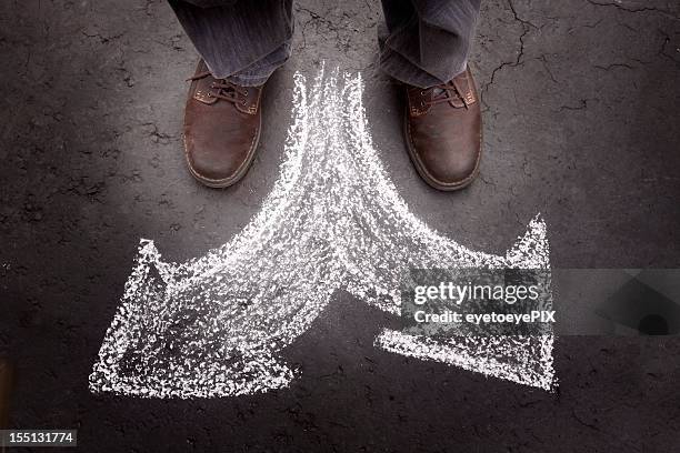 standing man with two choices (business) - career path stock pictures, royalty-free photos & images