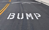 White bump road marking on black tarmac