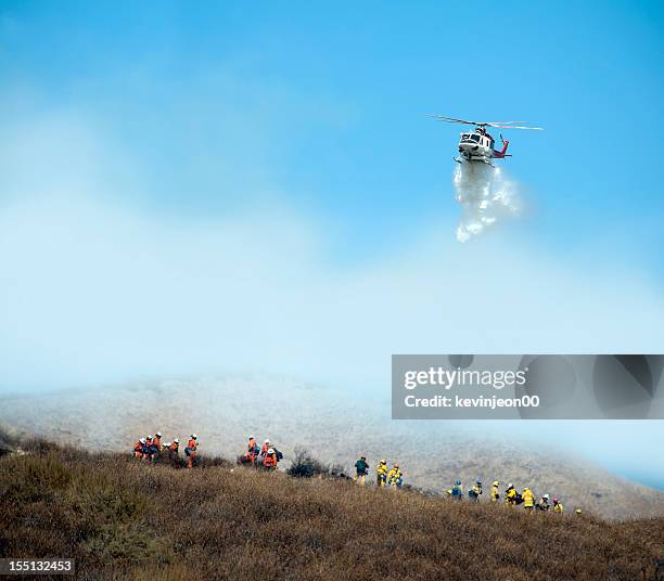 helicopter and firefighter - fighting forest fire stock pictures, royalty-free photos & images