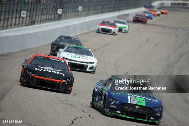 Cole Custer, driver of the Biohaven/Jacob Co. Ford, and Ross Chastain, driver of the Kubota Chevrolet, race during the NASCAR Cup Series Crayon 301...