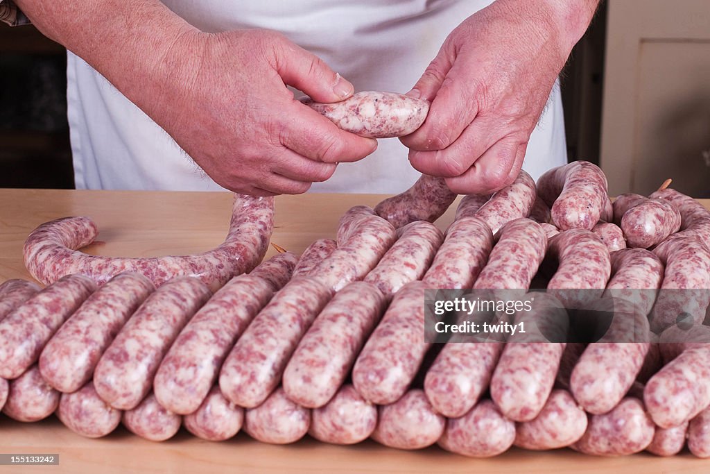 Butcher is making sausages